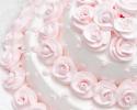 The pink frosting roses against the satin white icing makes this a perfect wedding cake for traditional receptions.