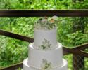 This 3-tiered white wedding cake is both classic and beautiful. The little love birds cake topper is just too cute when mixed with flowers and green berries. 