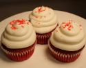 Amazingly delicious red velvet cupcakes topped with cream cheese icing and red sprinkles.