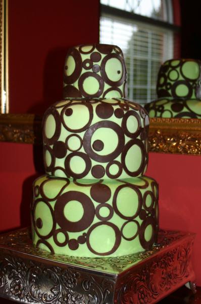 This green wedding cake is full of fun for the fabulous bride who knows just what she wants! The lime green cake icing is accented with dozens of delicious chocolate circles. 